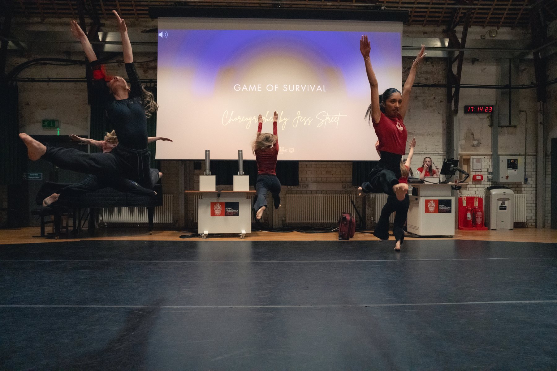 Trio of dancers captured mid-air in red and black
