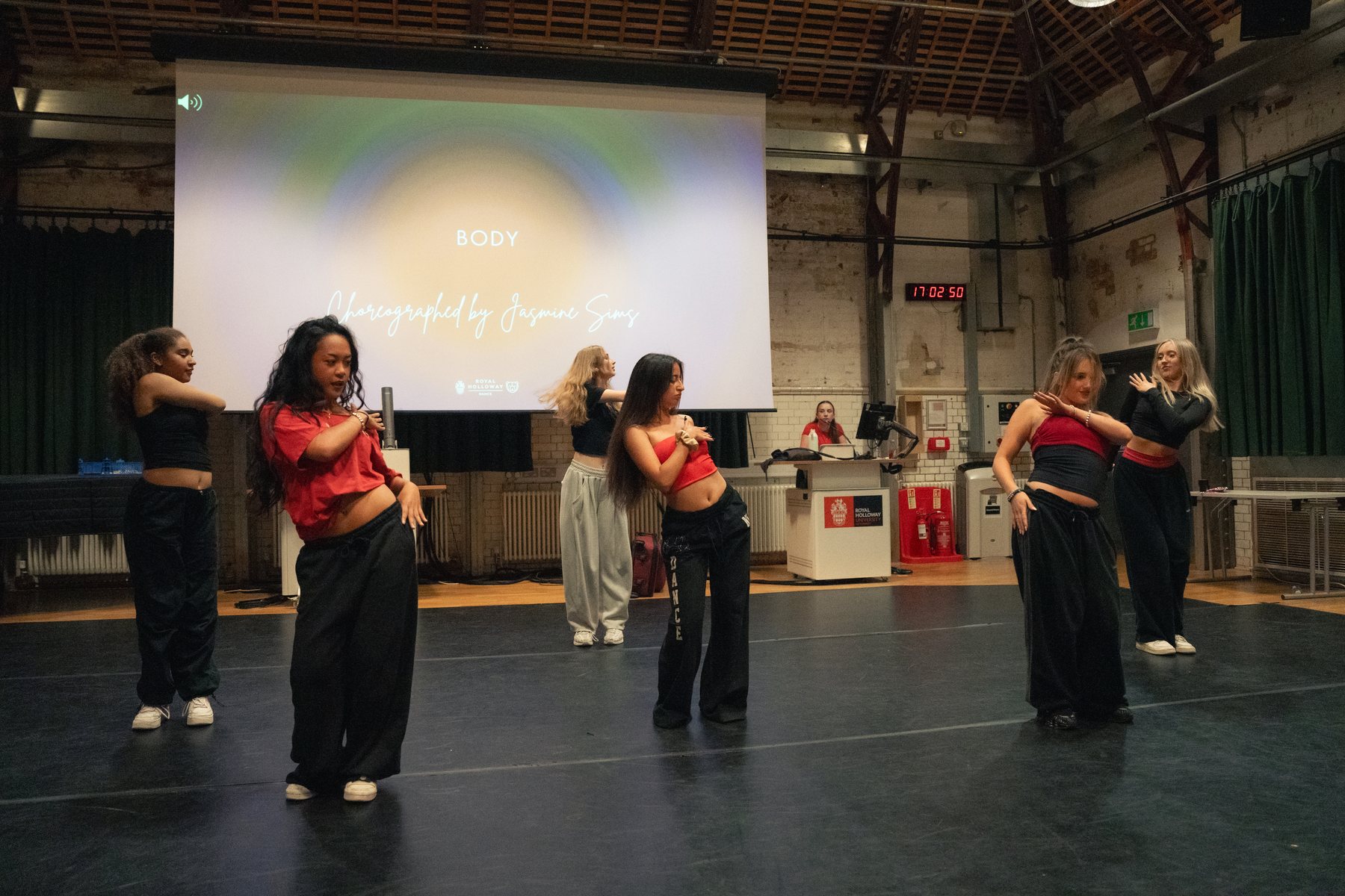 Dance group in red and black mid-routine