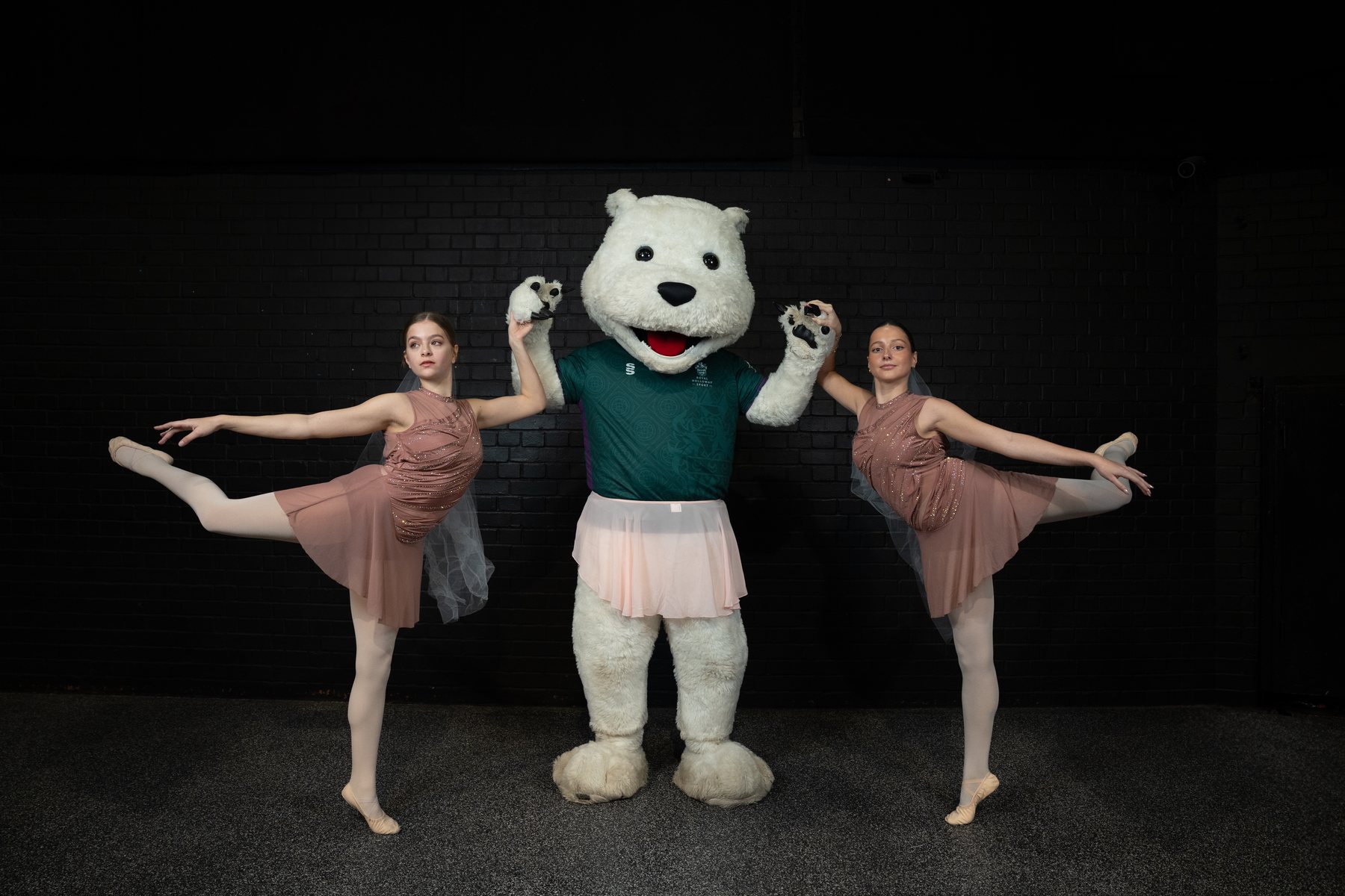 Symmetrical pose with the university mascot